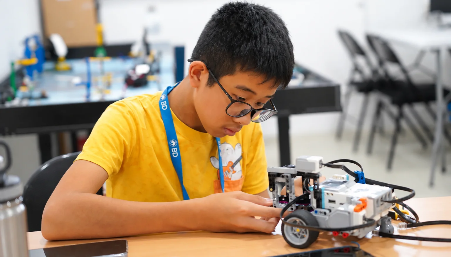 Student building an advanced robotic system