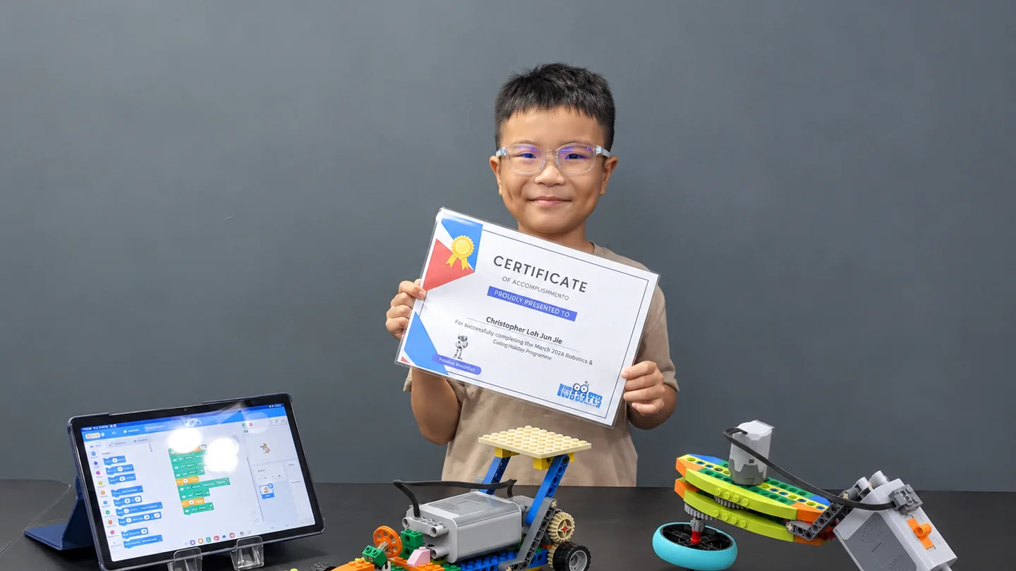 Child holding a robotics coding achievement certificate