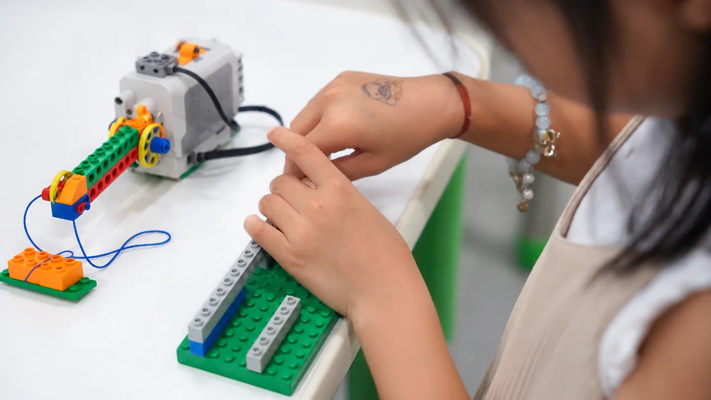 Child building a hands-on STEM robotics project